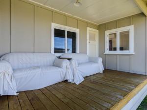 a living room with two white couches and a table at Harper Haven - Waimarama Holiday Home in Waimarama