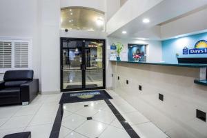 a waiting room at adq with a chair and a counter at Days Inn by Wyndham Phoenix North in Phoenix +37 photos