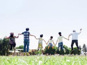a group of people holding hands in a field at Cabin House Yado Fujinomiya in Fujinomiya