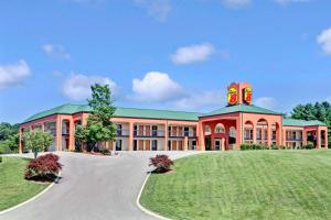 a large building with a road in front of it at Super 8 by Wyndham Knoxville East in Knoxville