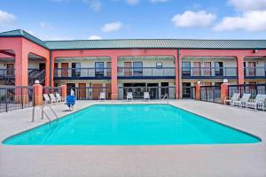 a swimming pool in front of a building at Super 8 by Wyndham Knoxville East in Knoxville
