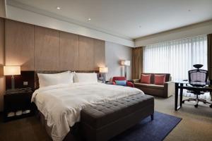 a hotel room with a large bed and a large window at The Tango Hotel Taipei XinYi in Taipei