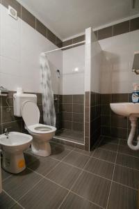 a bathroom with a toilet and a sink at Apartments Station in Konjic
