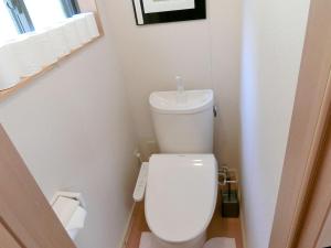 a small bathroom with a white toilet and a sink at Shirahama Meiji Villa in Shirahama