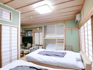 a bedroom with a bunk bed and a desk at Shirahama Meiji Villa in Shirahama
