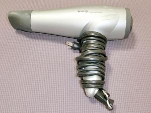 a gray and white blow dryer sitting on a table at Shirahama Meiji Villa in Shirahama