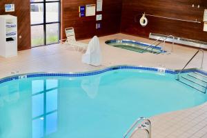 a large swimming pool in a building at Days Inn & Suites by Wyndham Wausau in Wausau