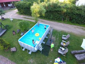 an overhead view of a pool with people playing with a frisbee at Gościniec Jawor in Ruciane-Nida