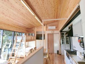 a tiny house with a kitchen and a living room at Shirahama Meiji Villa in Shirahama