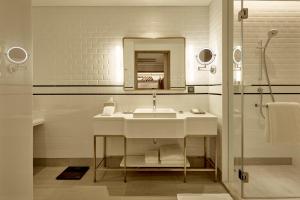 
a bathroom with a sink, toilet and bathtub at Montien Hotel Surawong Bangkok - SHA Extra Plus in Bangkok
