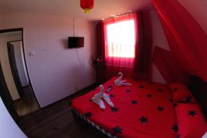 a bedroom with two dolls laying on a bed at Eden Garden Sovata in Sovata