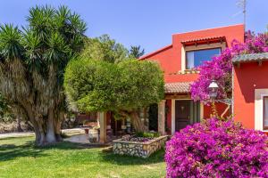 a house with pink flowers in front of it at Thai Garden Villa in Palma de Mallorca