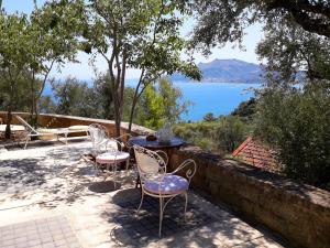 a table and chairs with a view of a lake at Villetta in Verde! Magnificent sea view in Akrotiri