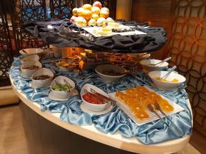 a buffet with different types of food on a table at Bahria Grand Hotel & Resort in Lahore