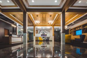 a living room with wood ceilings and a lobby at Quality Hotel & Conference Centre in Edmundston