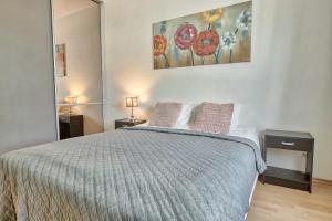 a bedroom with a large bed with two pillows at Daily Apartments - Tatari street in Tallinn