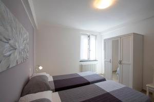 a bedroom with a bed in a white room at Casa Gardan in Levanto +73 photos