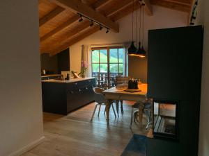 a kitchen with a table and chairs in a room at Mountainhome Birringer in Marktschellenberg