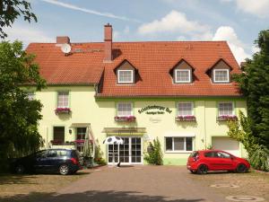 ein Haus mit zwei Autos, die davor geparkt sind in der Unterkunft Land-gut-Hotel Schenkenberger Hof in Delitzsch