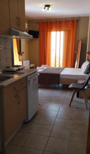 a small kitchen with a bed in the background at Villa Anastasia in Limenas