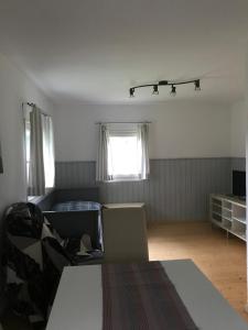 a living room with a bed and a window at Ferienhaus Marktl in Gnesau