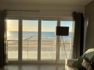 a room with a large window with a view of the ocean at Knappe studio met subliem zeezicht! in Ostend