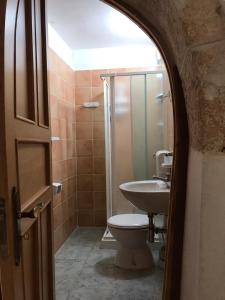 アルベロベッロにあるTrulli della Masseria Staffoneのバスルーム(洗面台、トイレ、シャワー付)