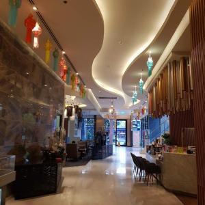a lobby with a restaurant with tables and chairs at 2 Bedroom apartment near Chiang mai Night Bazzar in Chiang Mai