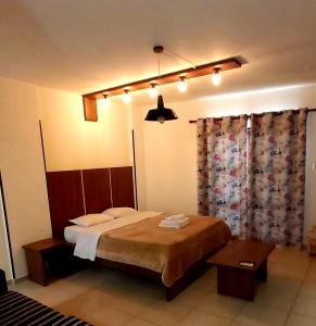 a bedroom with a large bed and a curtain at Lakis Court in Larnaca