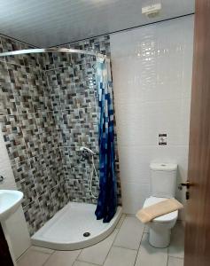 a bathroom with a shower with a toilet and a sink at Lakis Court in Larnaca +16 photos