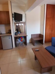 
a living room with a couch and a tv at Lakis Court in Larnaca
