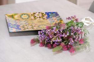 a bouquet of purple flowers sitting on a table at Thealassa in Kalliópi