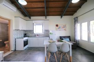 a kitchen with a table and chairs in a room at Thealassa in Kalliópi