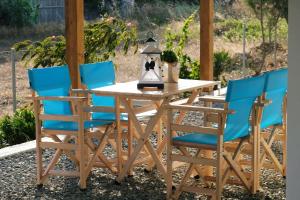 a wooden table with chairs and a tea kettle on it at Thealassa in Kalliópi