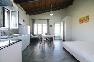 a kitchen with a bed and a table in a room at Thealassa in Kalliópi