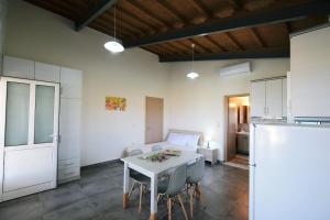 a kitchen and dining room with a table and chairs at Thealassa in Kalliópi