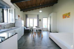 a kitchen with a bed and a table in a room at Thealassa in Kalliópi