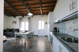 a kitchen and living room with a table and a sink at Thealassa in Kalliópi