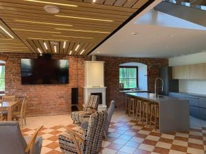 a kitchen with a tv and a brick wall at Riverside Villa in Luunja