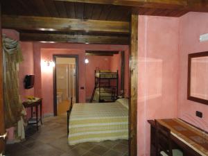 a bedroom with a bed in a room with pink walls at Green House in Morano Calabro