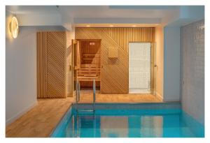 a house with a swimming pool in a room at Lyric Hotel Paris Opera in Paris