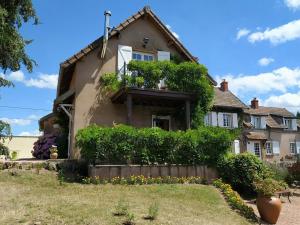 a house with a fence in front of it at Le Serpolet in Ozolles