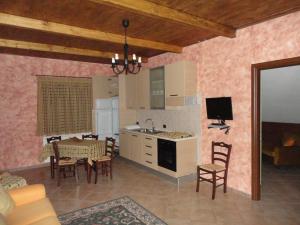 a kitchen and dining room with a table and chairs at Green House in Morano Calabro