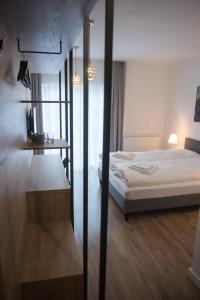 a bedroom with a bed and a desk in it at Stará Pošta in Svidník