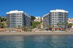 a beach area with a large building and a large body of water at Melia Costa del Sol in Torremolinos