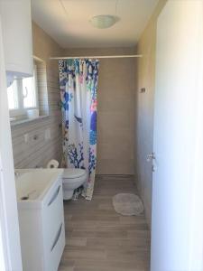 a bathroom with a toilet and a shower curtain at Apartment Sunset - New! in Krk +31 photos