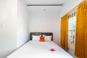 Postel nebo postele na pokoji v ubytování RedDoorz Plus near Soekarno Hatta Airport Taman Mahkota