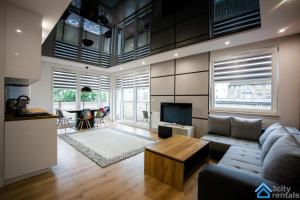 a living room with a couch and a table at Apartment Showtime Gdańsk in Gdańsk