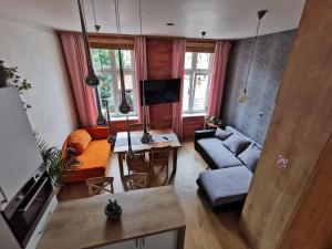 a living room with a couch and a table at Apartament Słoneczny na Placu Wejhera in Wejherowo