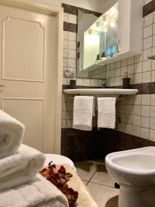 a bathroom with a sink and a toilet and towels at Pancrazio in Taormina +20 photos